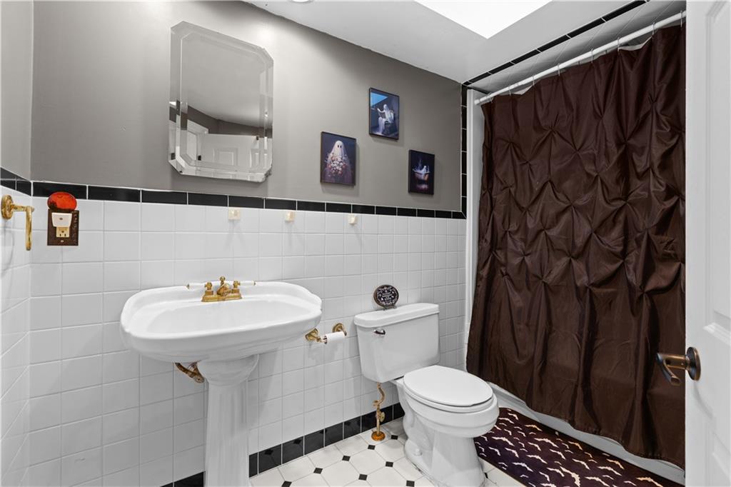 710 5th Street Charleroi, PA 15022 - Photo 17 of 30 a bathroom with a sink mirror and toilet