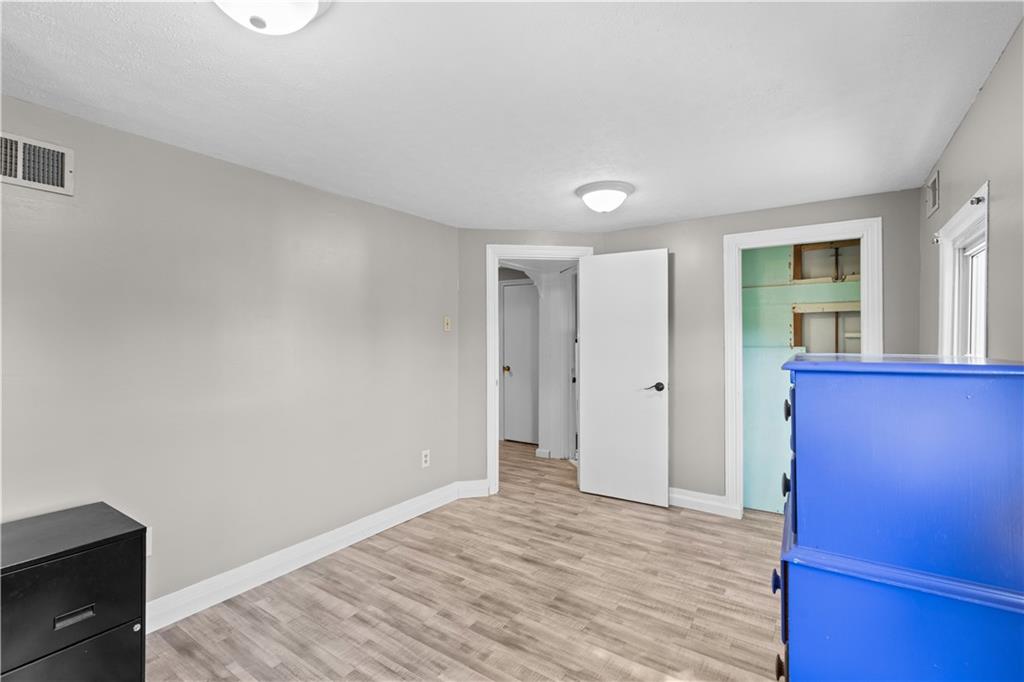 710 5th Street Charleroi, PA 15022 - Photo 23 of 30 a view of an empty room with wooden floor and a window