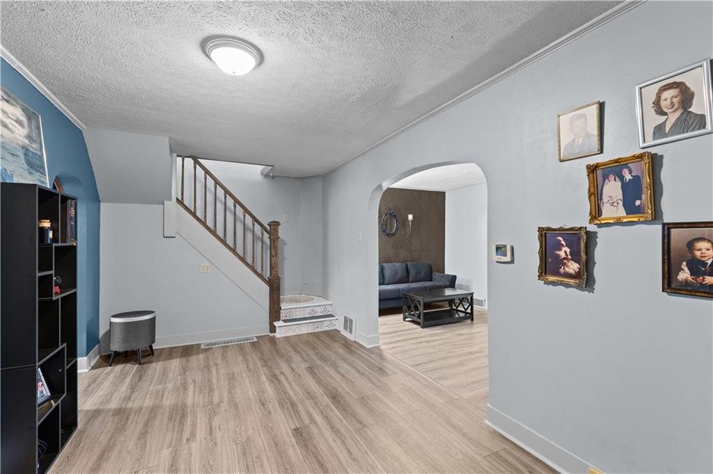 710 5th Street Charleroi, PA 15022 - Photo 6 of 30 a view of empty room with stairs and wooden floor