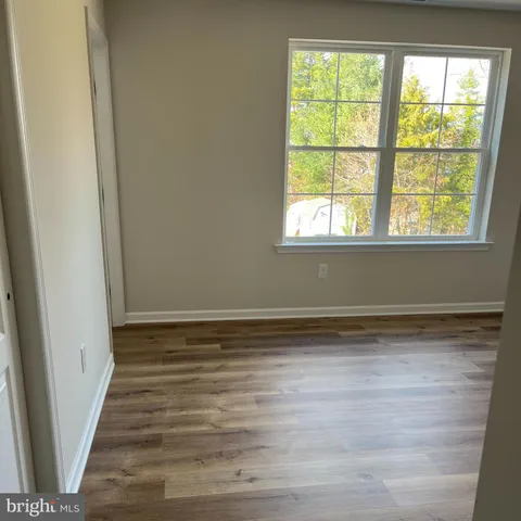 a view of a room with window and wooden floor