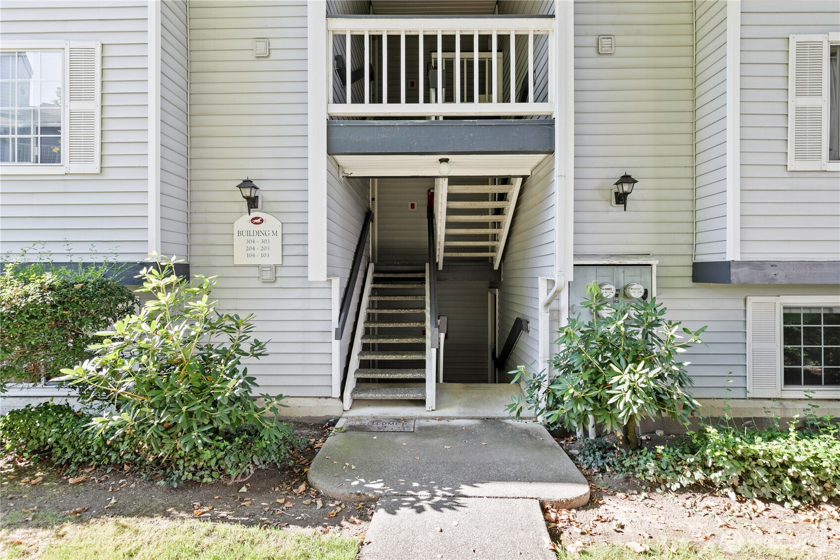 7453 Newcastle Golf Club Road, Unit M103 Newcastle, WA 98059 - Photo 14 of 18 a front view of a house with stairs
