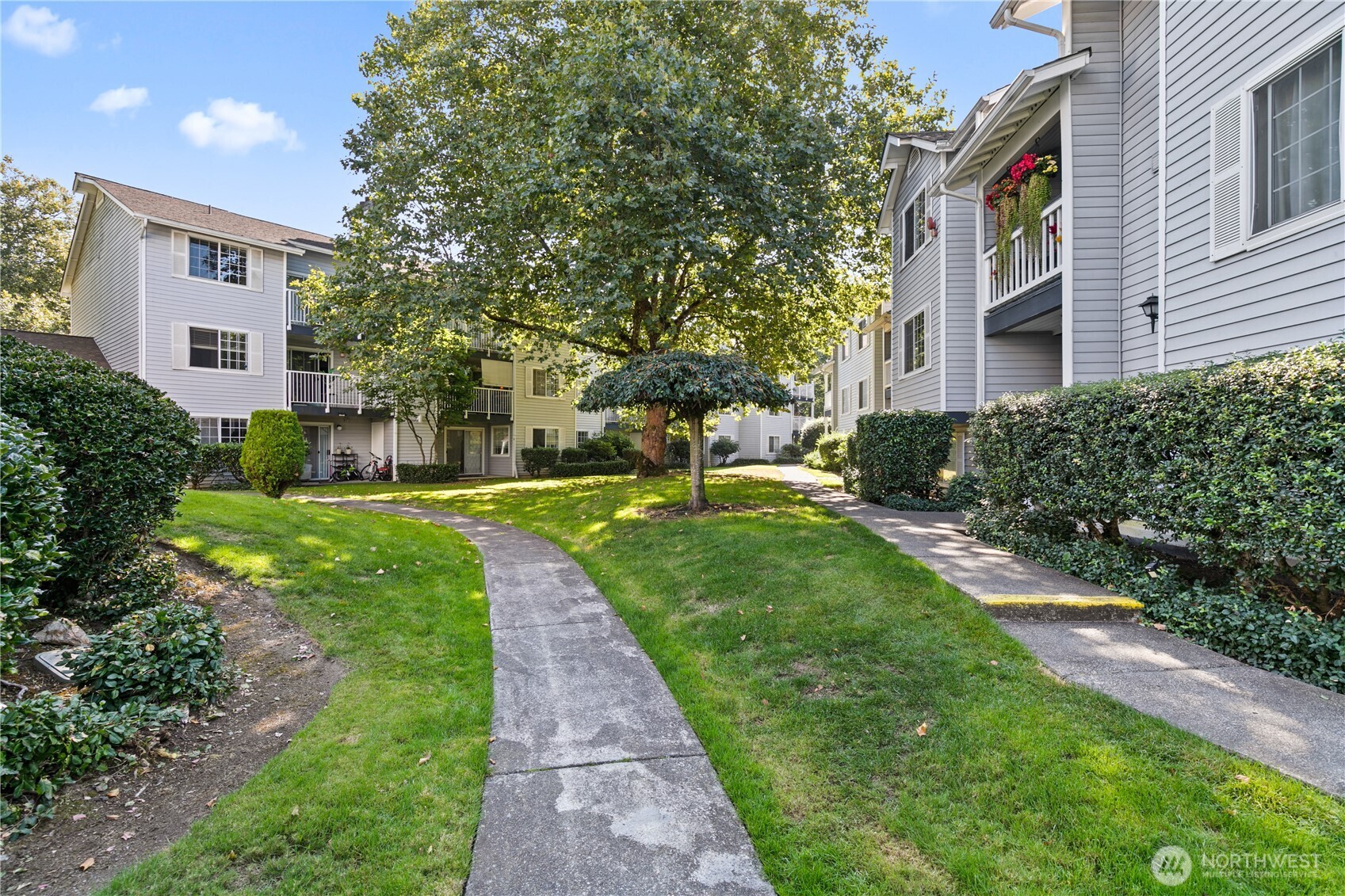 7453 Newcastle Golf Club Road, Unit M103 Newcastle, WA 98059 - Photo 15 of 18 a view of a building with a yard