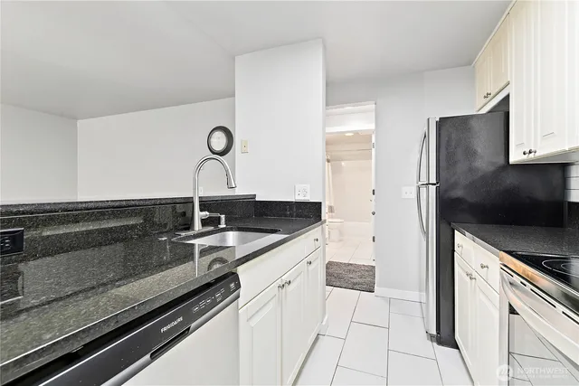 a kitchen with a sink and stainless steel appliances