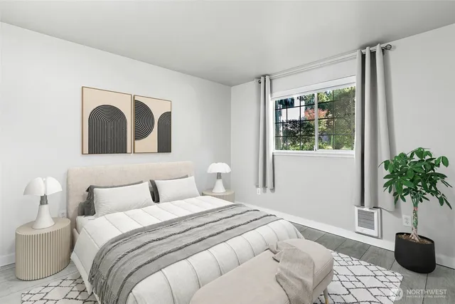 a bedroom with a bed and a potted plant