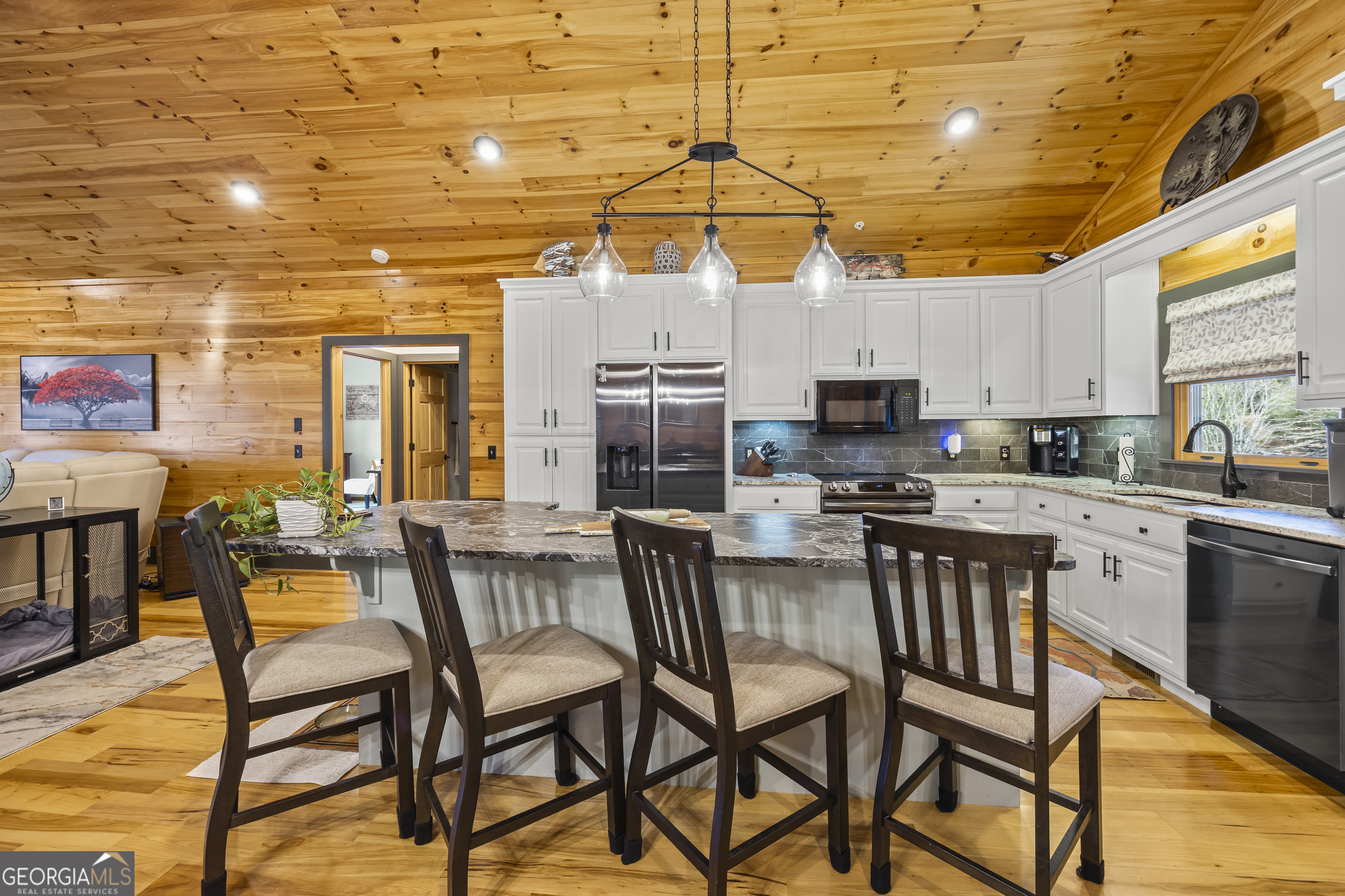 299 Celestial Circle Clayton, GA 30525 - Photo 18 of 89 a kitchen with stainless steel appliances granite countertop a stove a refrigerator a kitchen island with chairs and white cabinets