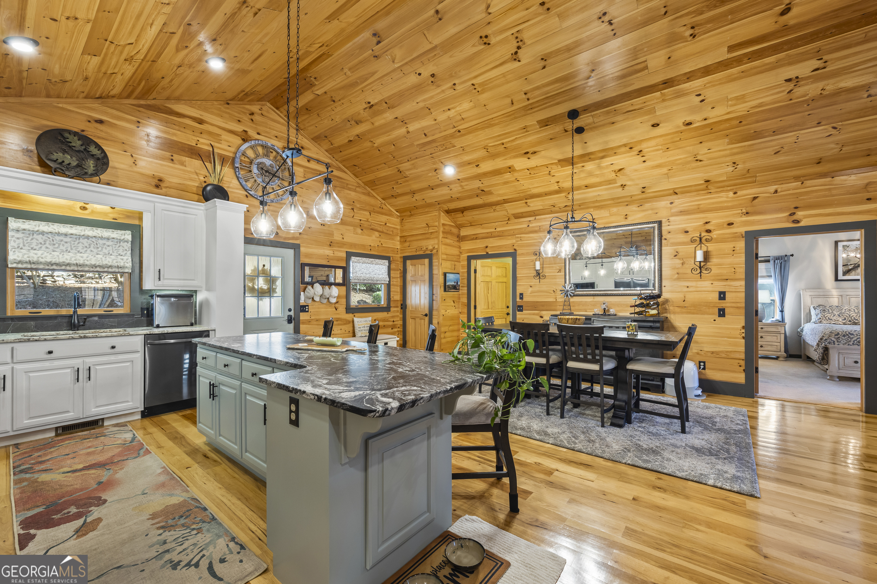 299 Celestial Circle Clayton, GA 30525 - Photo 20 of 89 a kitchen with stainless steel appliances granite countertop a stove a sink a dining table and chairs with wooden floor