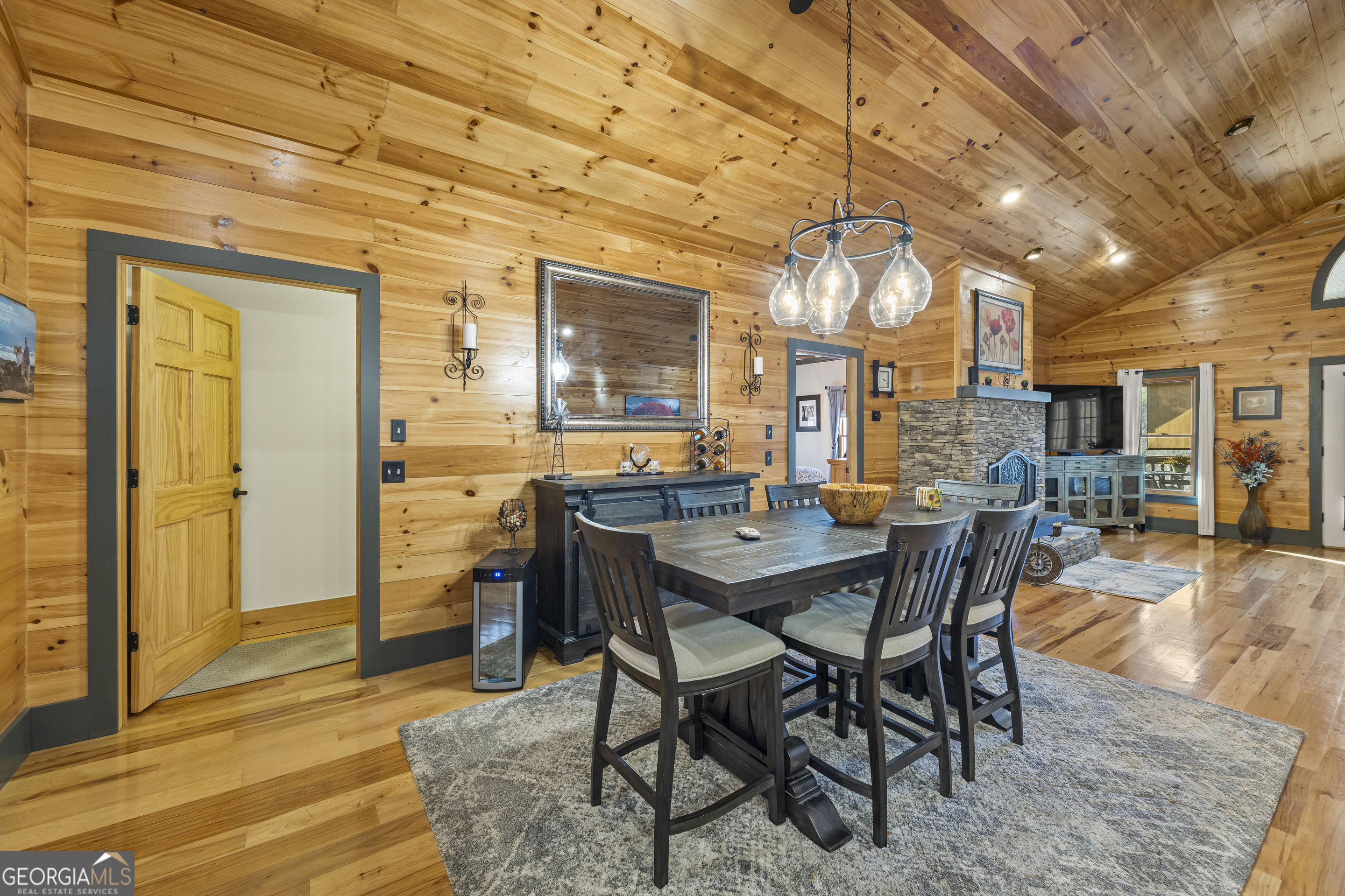 299 Celestial Circle Clayton, GA 30525 - Photo 24 of 89 a dining room with wooden floor a chandelier a wooden table and chairs