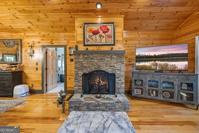 a living room with furniture a flat screen tv and a table