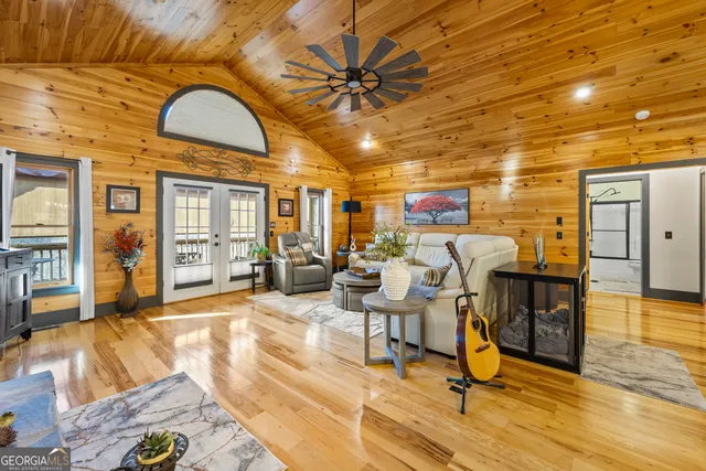 a living room with lots of furniture and kitchen view