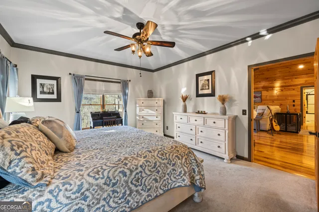 a bedroom with a bed next to a window