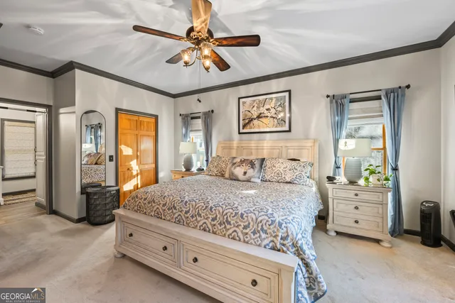 a bedroom with a bed and a painting on the wall