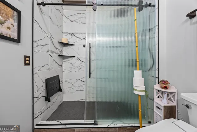 a bathroom with a sink a mirror and a shower