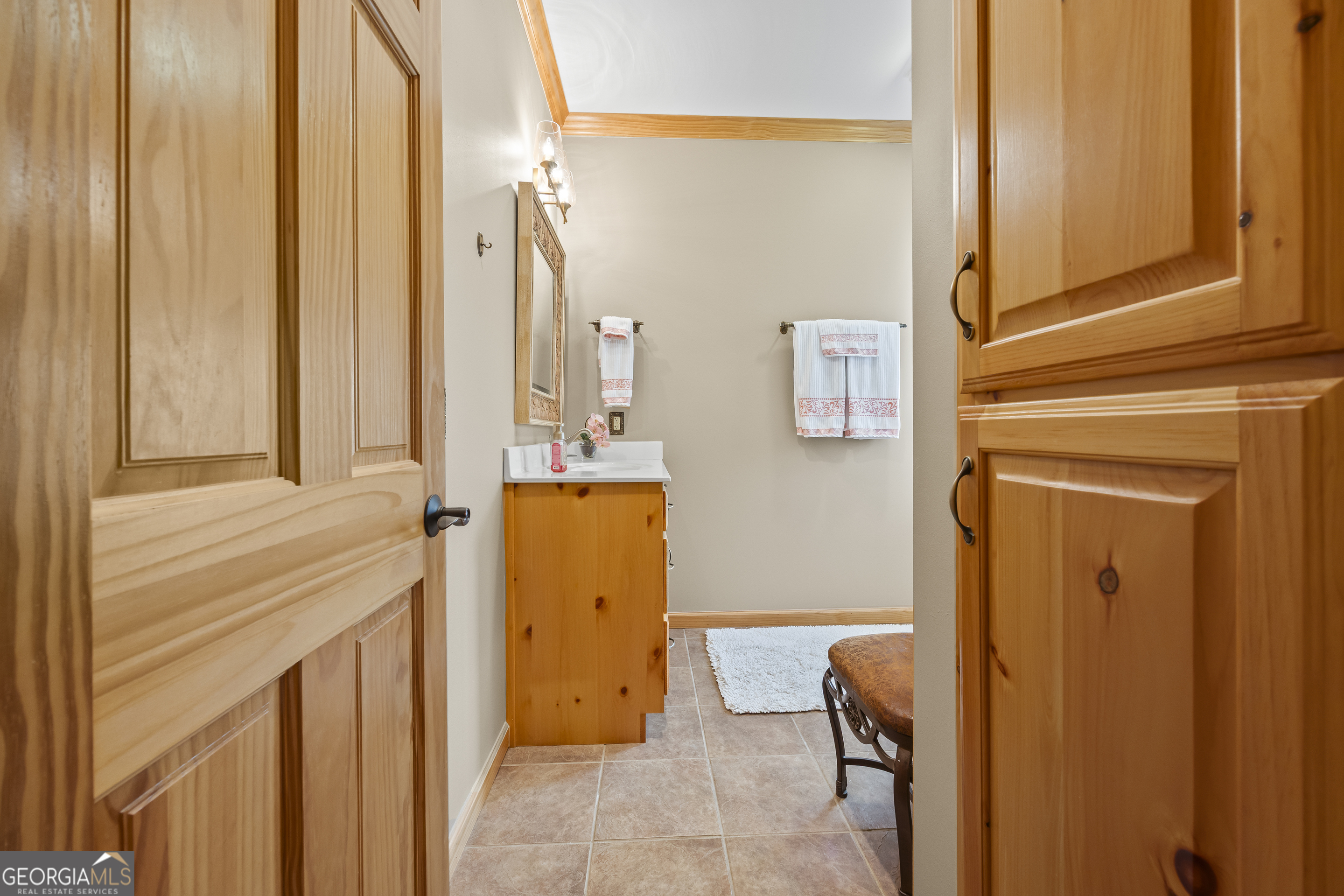 299 Celestial Circle Clayton, GA 30525 - Photo 56 of 89 a bathroom with a sink a mirror and a shower