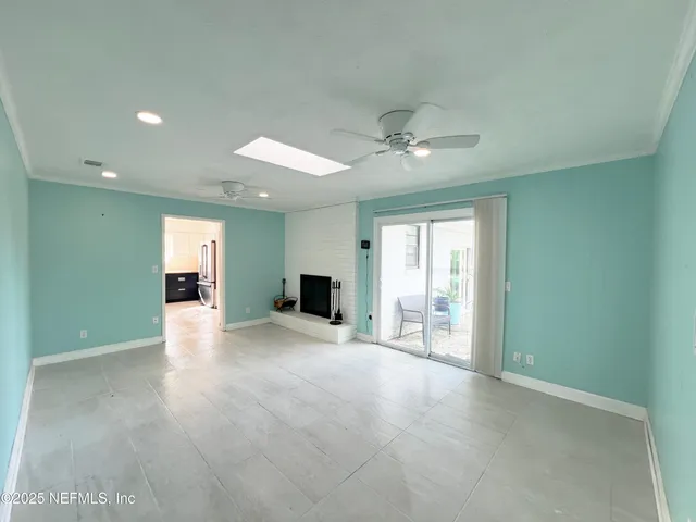 a view of an empty room with a window