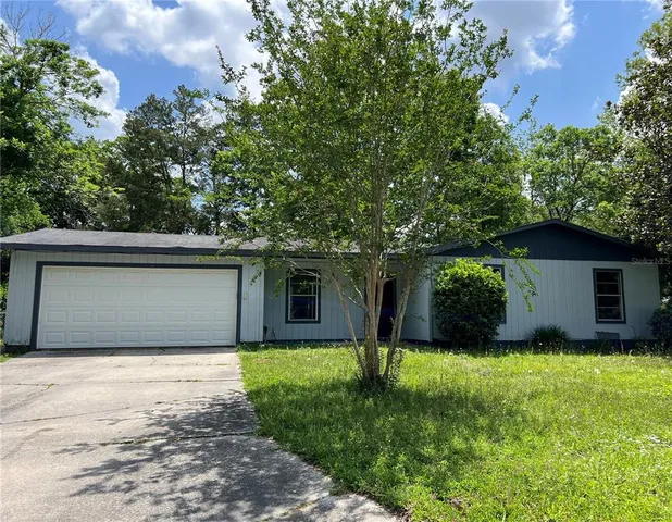 a front view of house with yard and trees