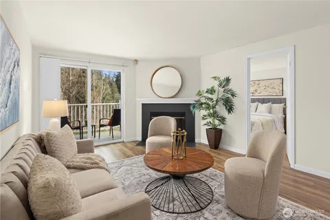a living room with furniture potted plant and a large window
