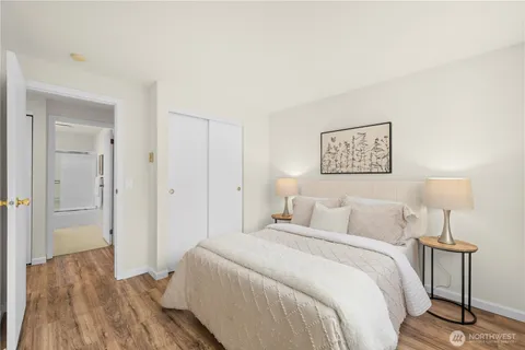 a bedroom with a bed and a lamp