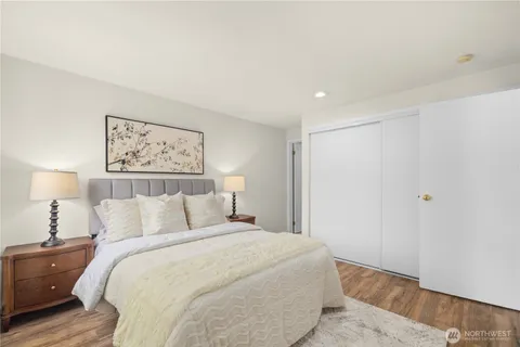 a bedroom with a bed and a night stand