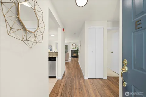 a view of a hallway with wooden floor and staircase