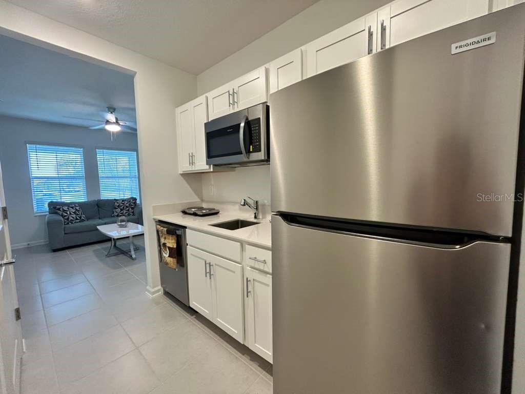 3258 Armstrong Avenue Clermont, FL 34714 - Photo 11 of 18 a kitchen with stainless steel appliances a refrigerator sink and microwave