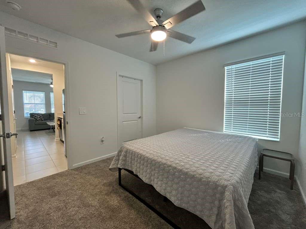 3258 Armstrong Avenue Clermont, FL 34714 - Photo 13 of 18 a bedroom with a bed and a chandelier