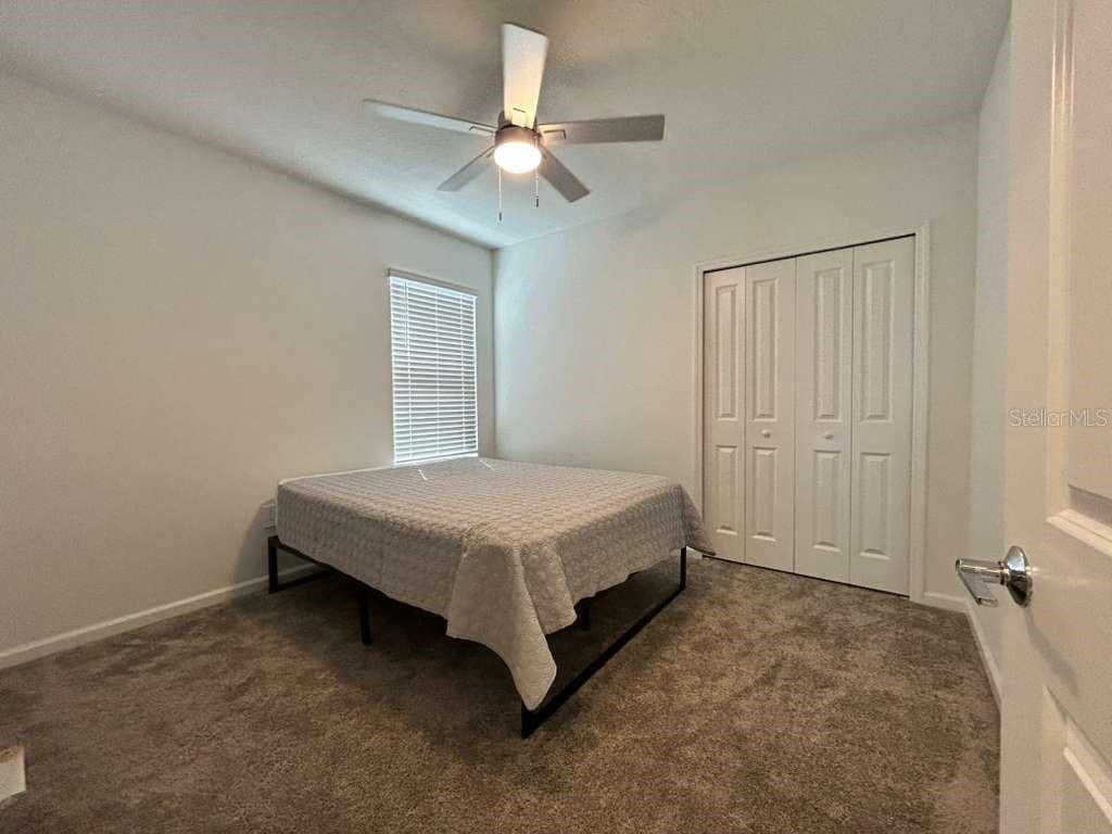 3258 Armstrong Avenue Clermont, FL 34714 - Photo 14 of 18 a spacious bedroom with a bed and a chandelier