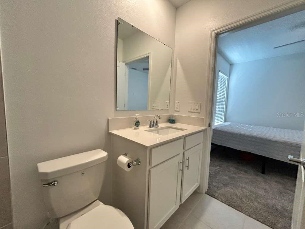 3258 Armstrong Avenue Clermont, FL 34714 - Photo 16 of 18 a bathroom with a sink mirror vanity and toilet