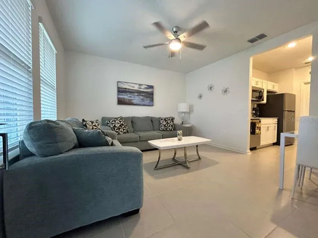 a living room with furniture and a chandelier