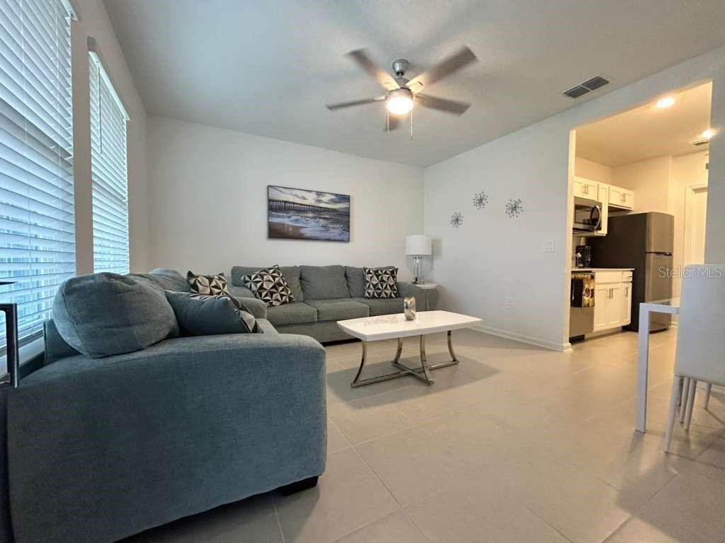3258 Armstrong Avenue Clermont, FL 34714 - Photo 3 of 18 a living room with furniture and a chandelier