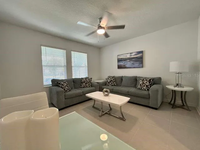 a living room with furniture and a large window