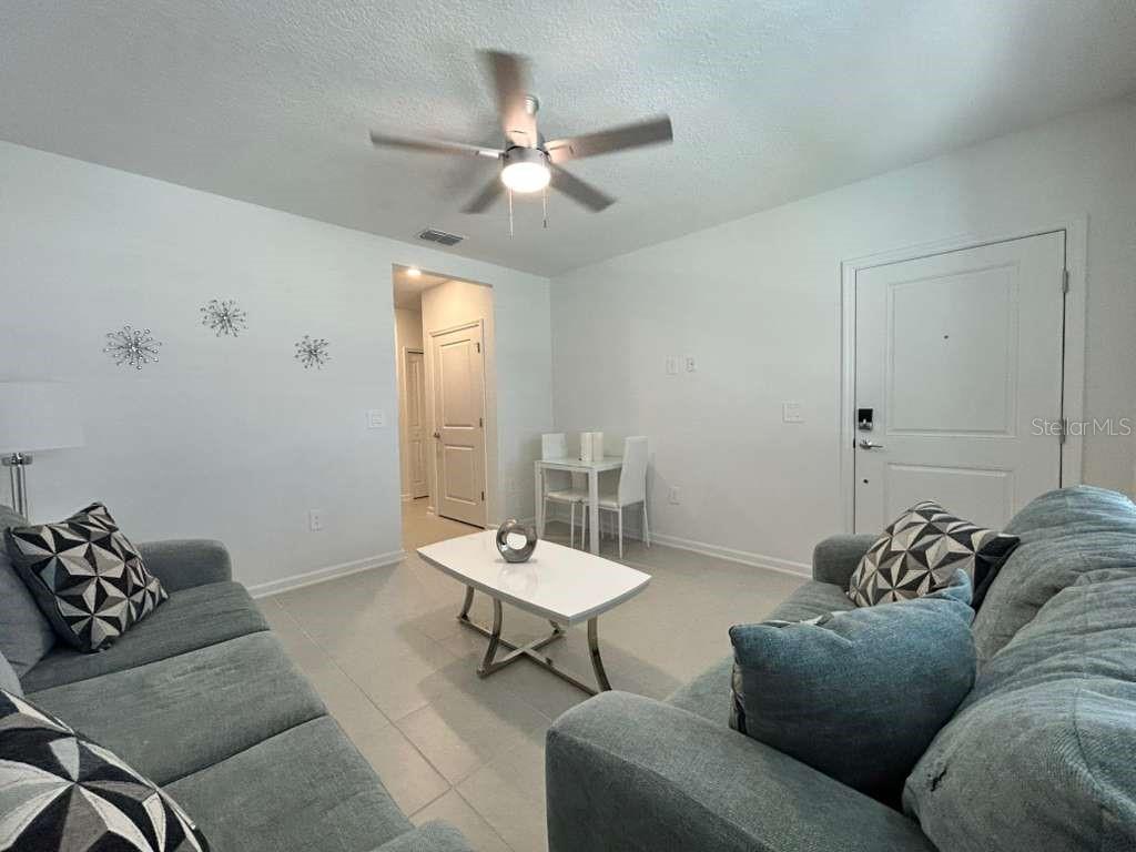 3258 Armstrong Avenue Clermont, FL 34714 - Photo 5 of 18 a living room with furniture and a chandelier