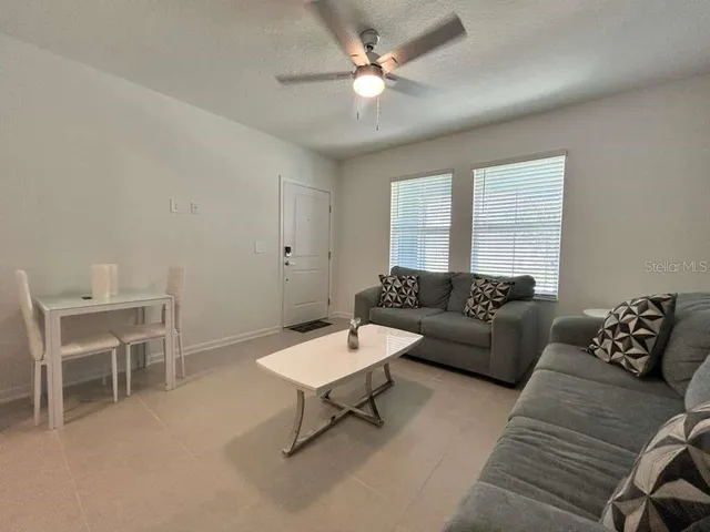 a living room with furniture and a chandelier