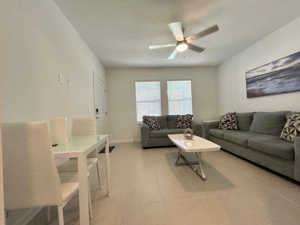 3258 Armstrong Avenue Clermont, FL 34714 - Photo 8 of 18 a living room with furniture and a ceiling fan