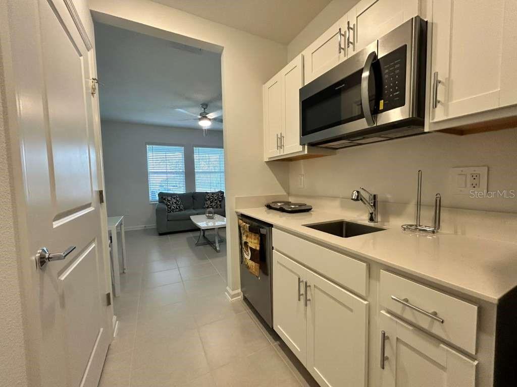 3258 Armstrong Avenue Clermont, FL 34714 - Photo 10 of 18 a kitchen with stainless steel appliances granite countertop a sink and a microwave