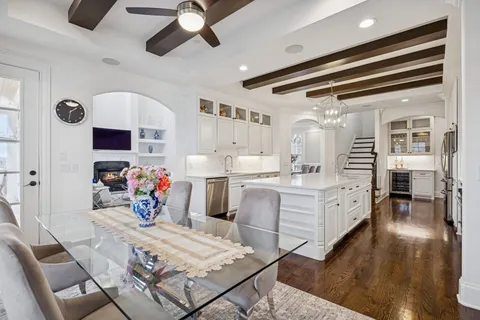 a view of an entryway with wooden floor and cabinets