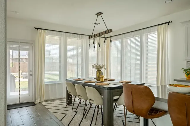 a view of a dining room with furniture and window