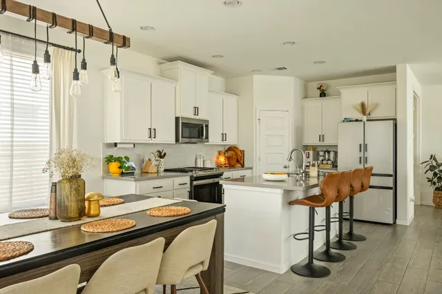 a kitchen with a sink appliances and cabinets
