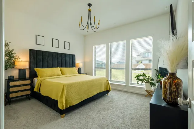 a bed sitting in a bedroom next to a window
