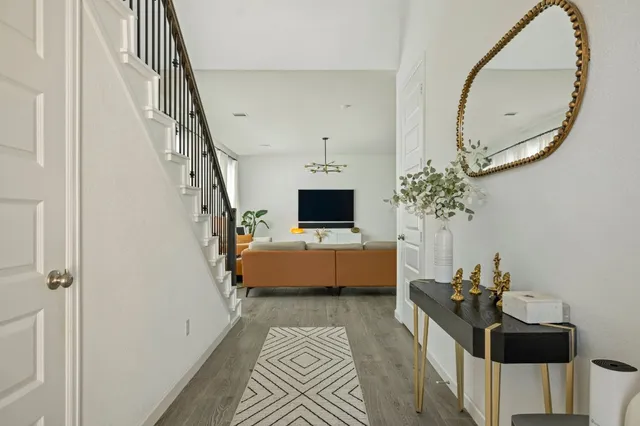 a living room with furniture and a mirror