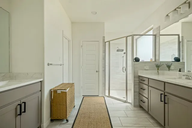 a bathroom with a tub a sink and mirrors