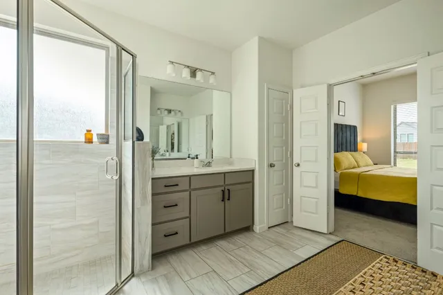 a bathroom with a tub sink and mirror