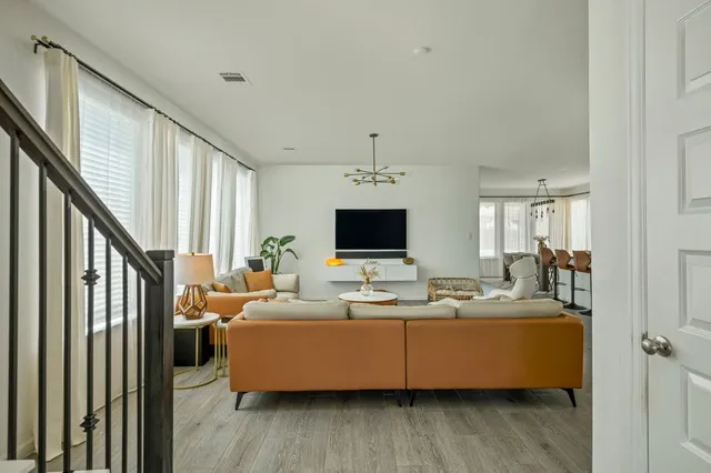 a living room with furniture wooden floor and flat screen tv