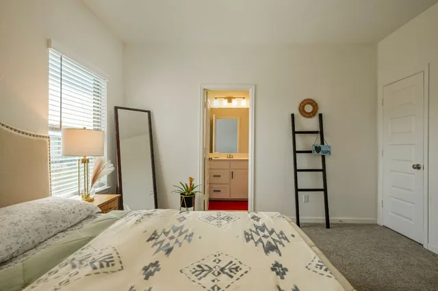 a bathroom with a sink a toilet a mirror and shower curtain