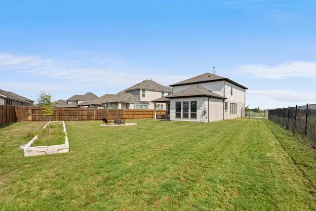 a view of a house with garden space and sitting area