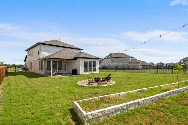 a view of a house with backyard and a slide