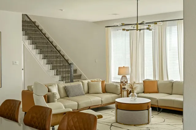 a living room with furniture and a chandelier