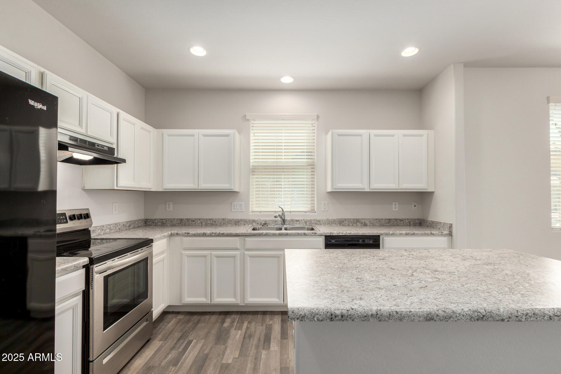 5470 Fulton Street Phoenix, AZ 85043 - Photo 13 of 33 a kitchen with stainless steel appliances granite countertop a stove a sink and white cabinets
