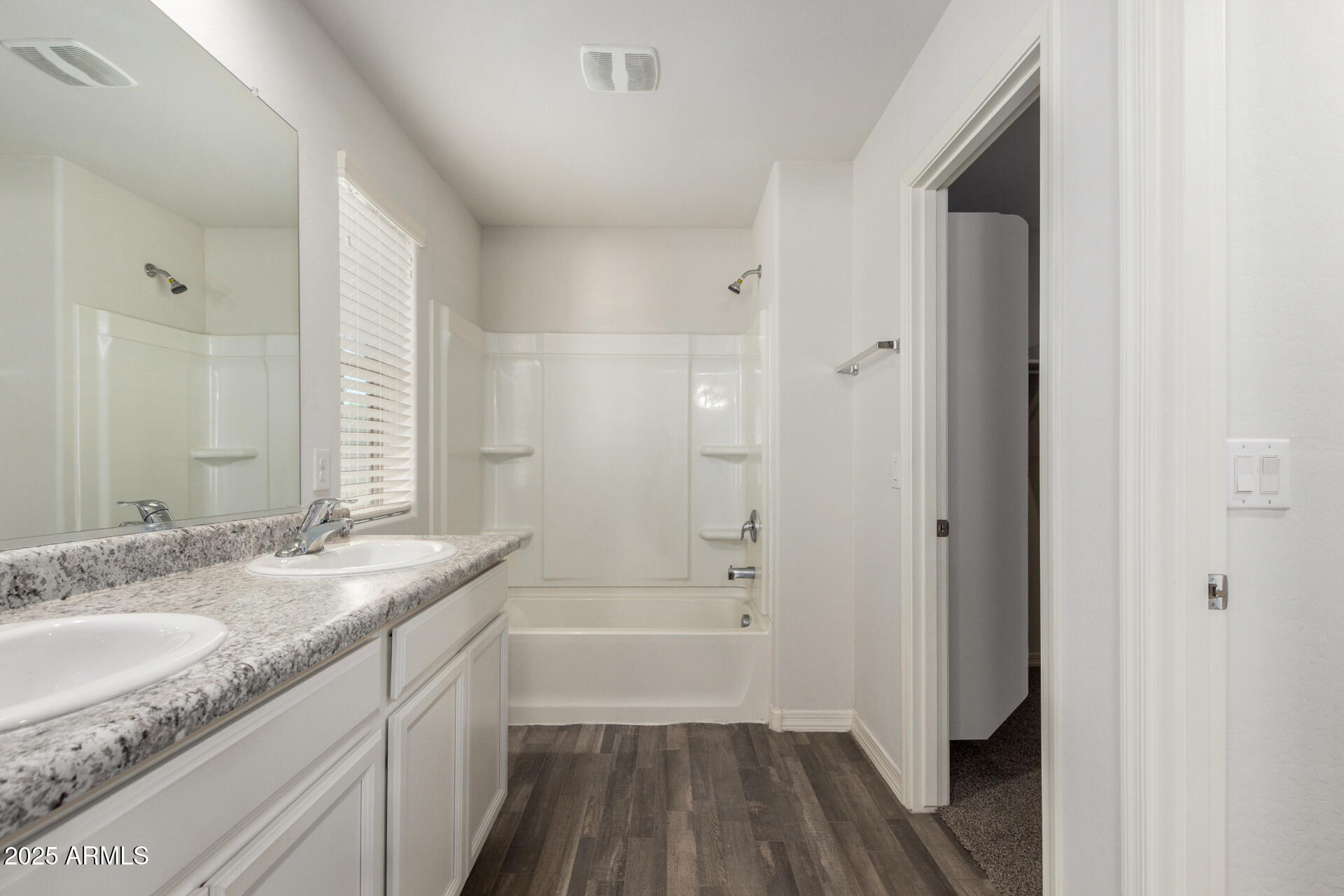 5470 Fulton Street Phoenix, AZ 85043 - Photo 20 of 33 a bathroom with a granite countertop sink a mirror and a bathtub