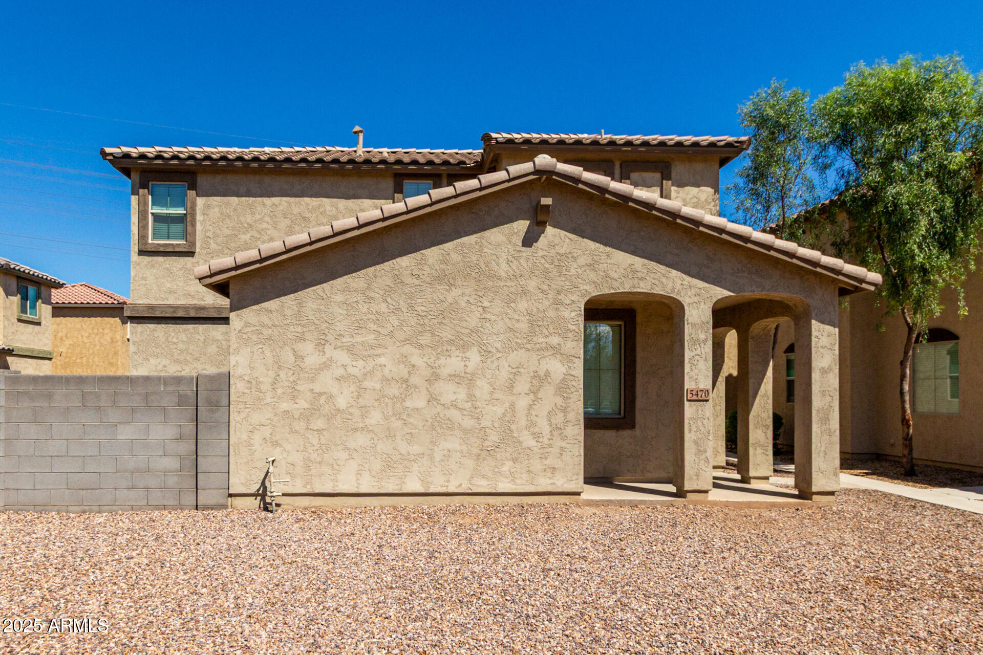 5470 Fulton Street Phoenix, AZ 85043 - Photo 2 of 33 a front view of a house with a garden