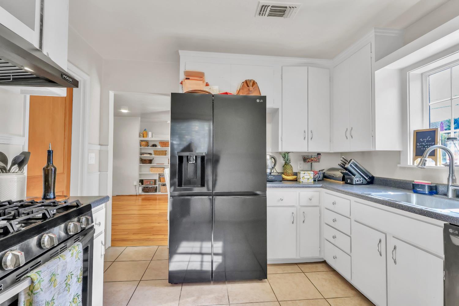 606 West Turner Road Lodi, CA 95240 - Photo 16 of 41 a kitchen with white cabinets and appliances